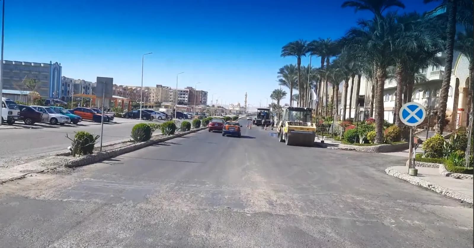 Northern Hurghada hotel strip with palms and road resurfacing on the route to El Gouna